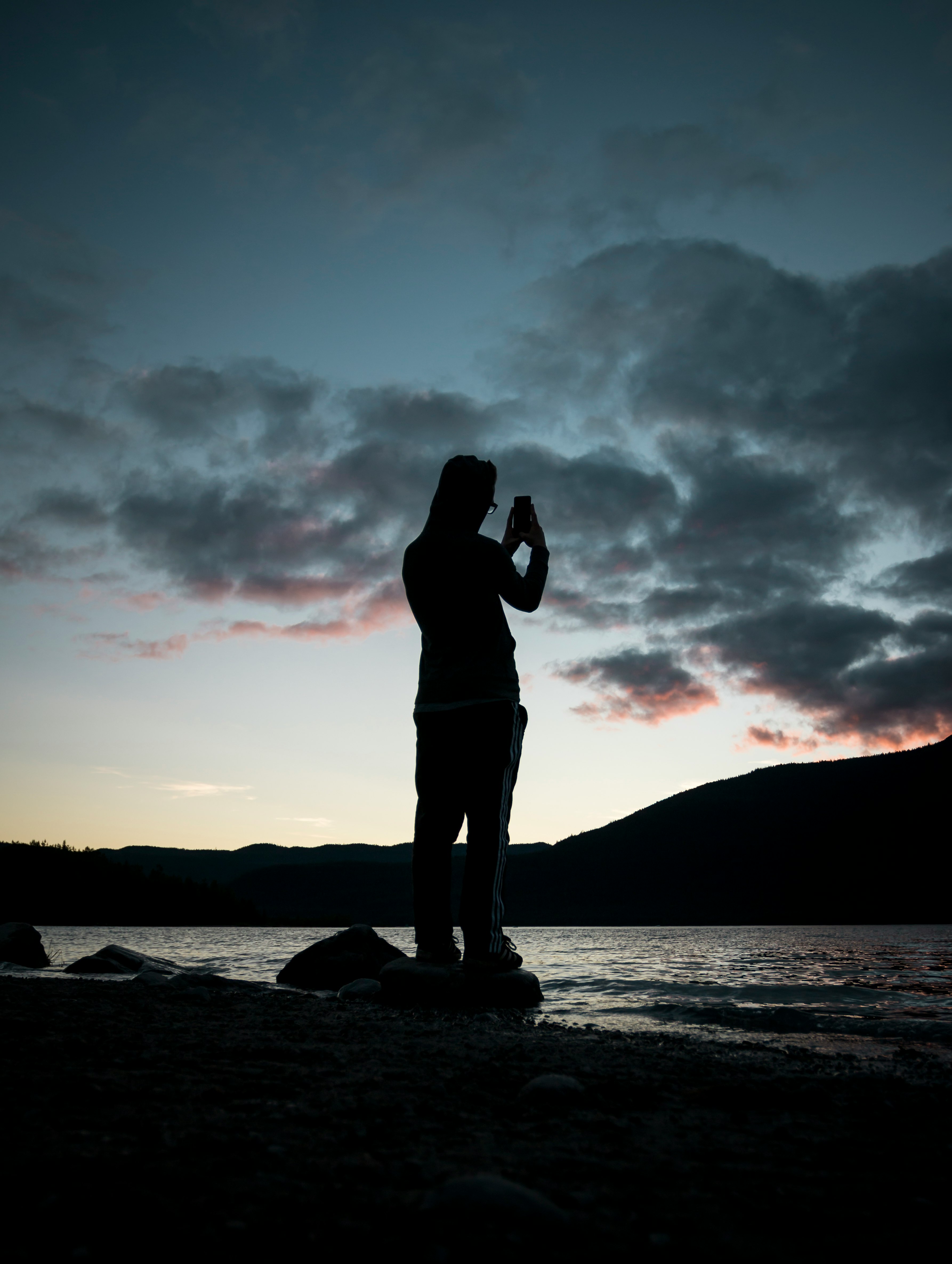 silhouette of person near body of water